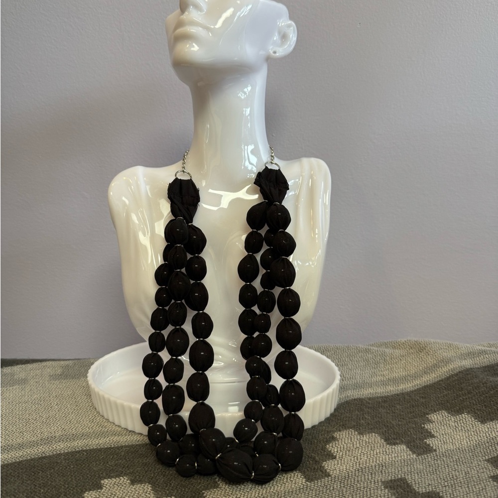 Ball necklace, glass beads covered with fabric.